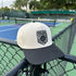 White cap with pickleball USA logo on a tennis court